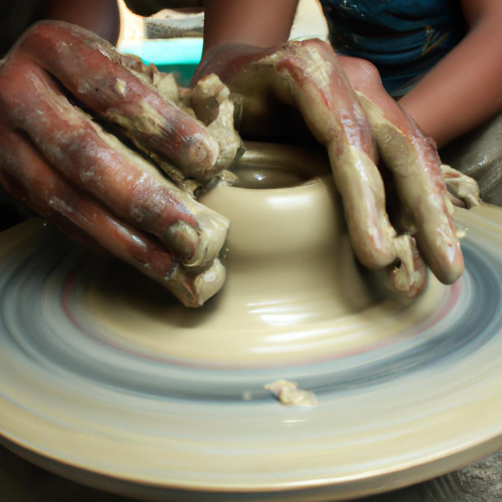 Person sculpting clay on wheel
