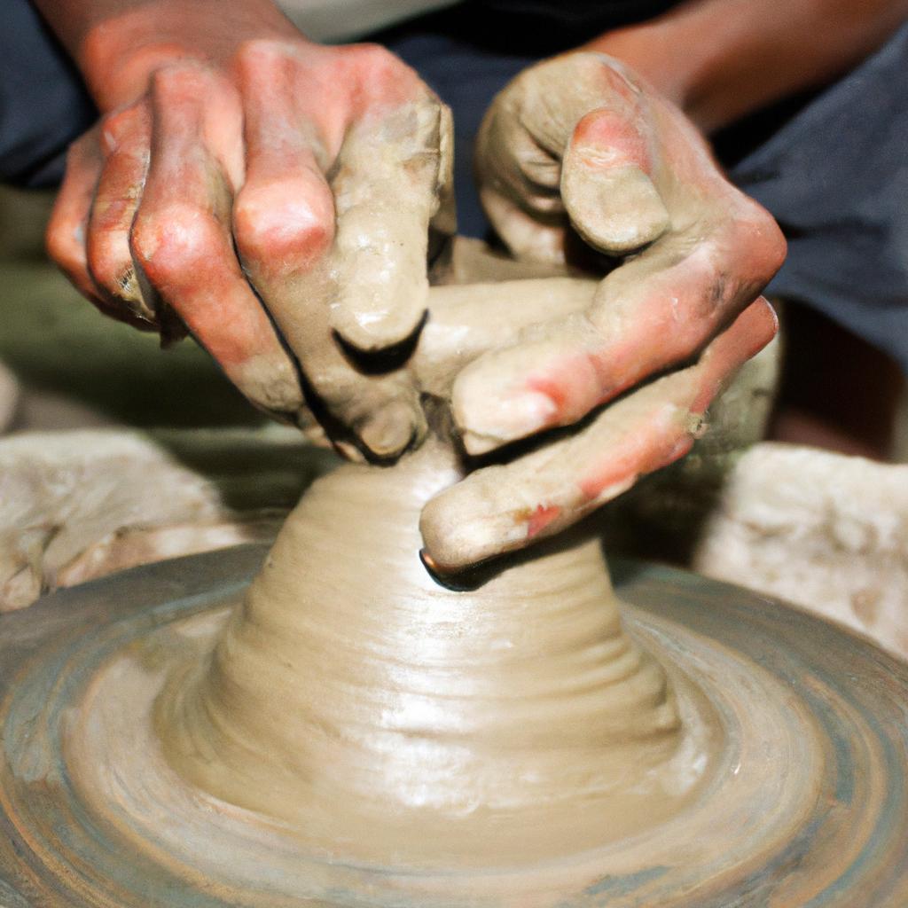 Potter shaping clay on wheel